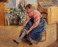 woman putting on her stockings 1895 Camille Pissarro